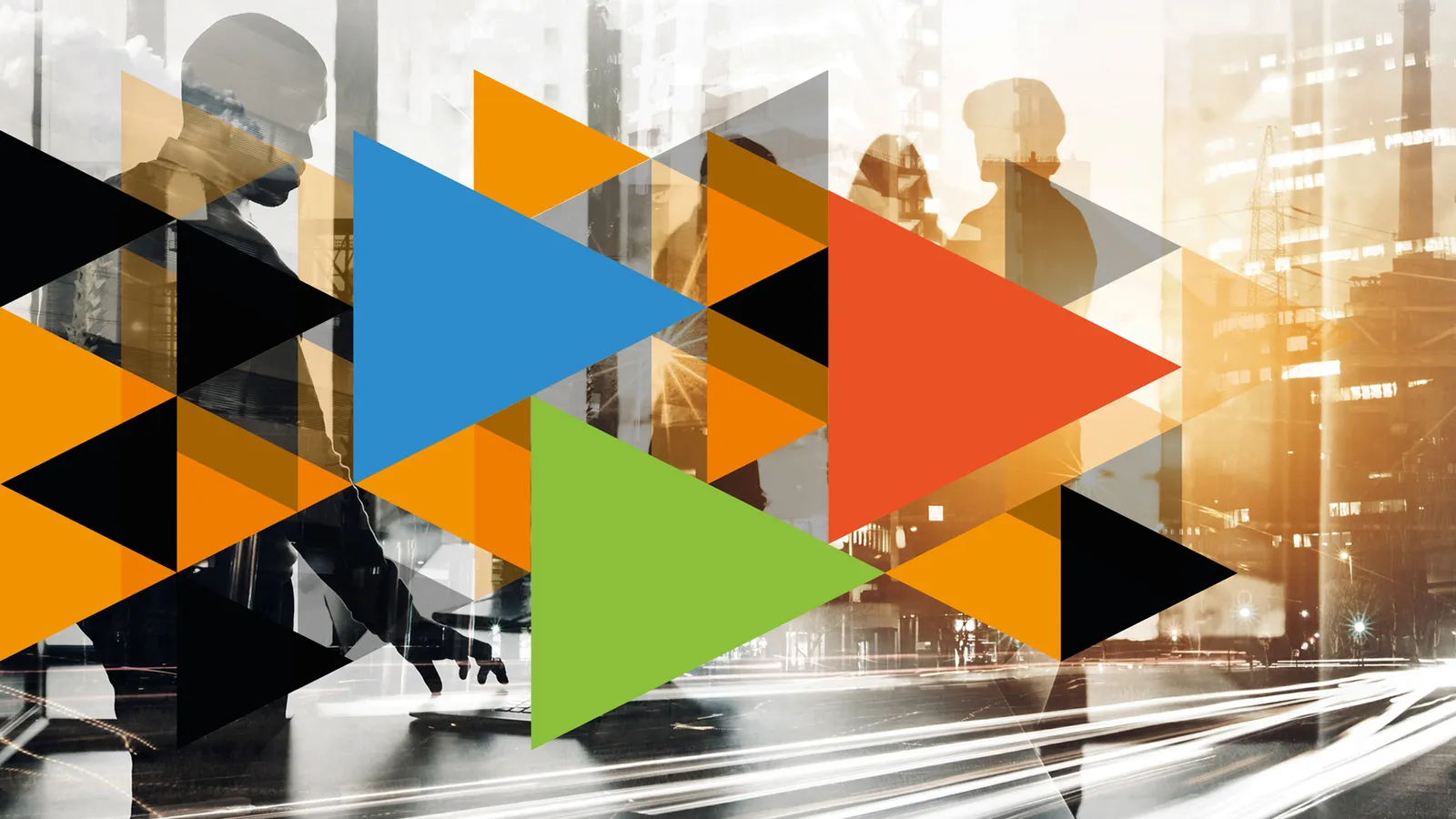 Abstract design of coloured triangles over a blurred black-and-white city street at dusk